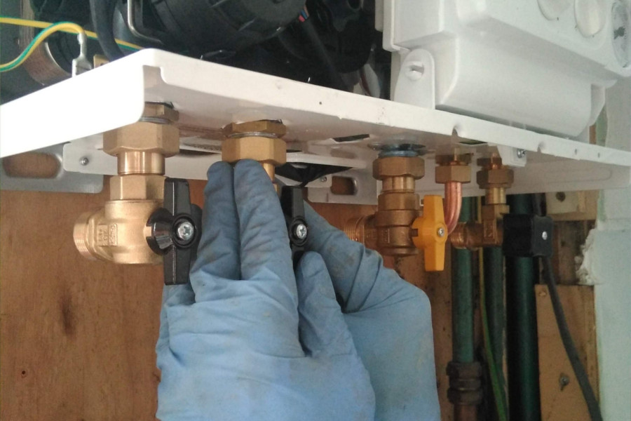 central heating engineer installing a boiler